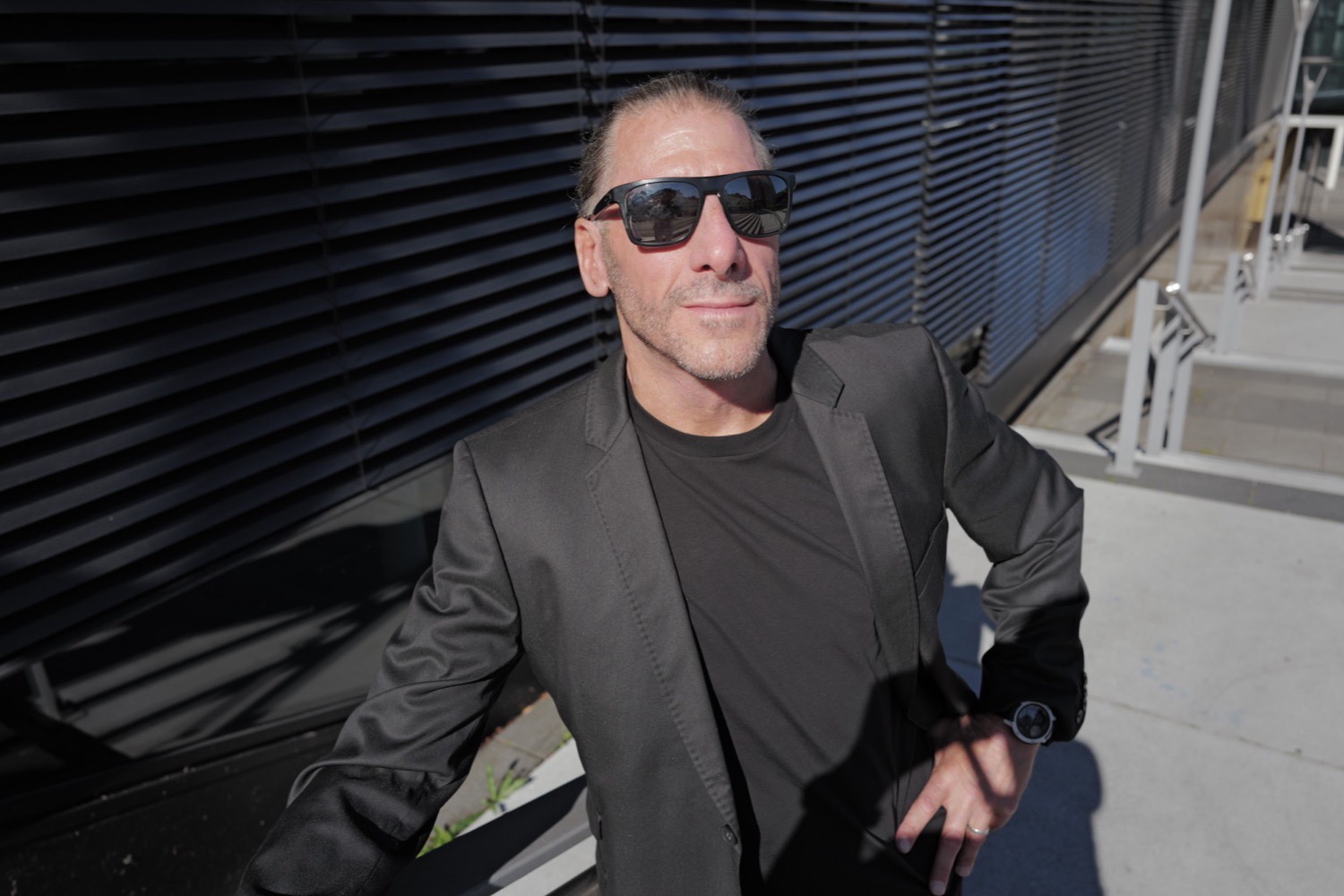 Mann mit Sonnenbrille blickt ins Sonnenlicht